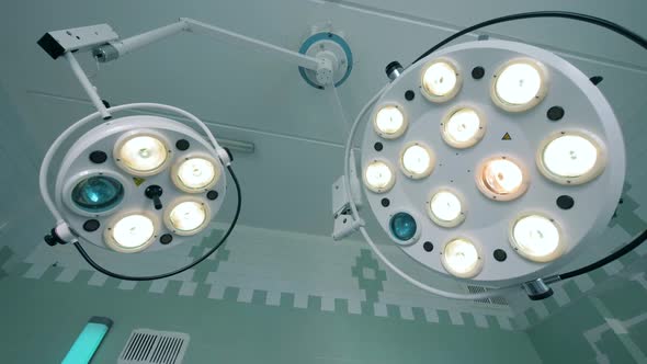 Two Functioning Medical Lamps Hanging Under the Ceiling