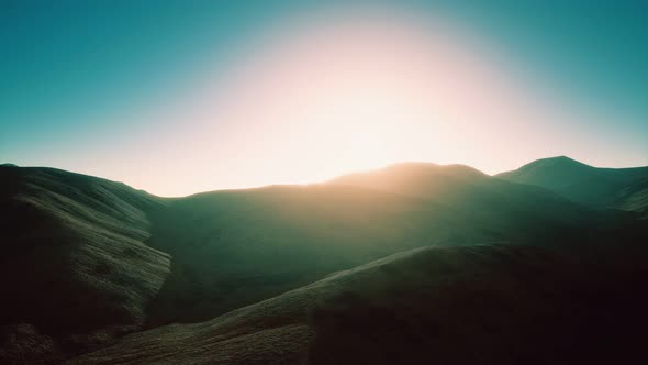 Hills with Rocks at Sunset