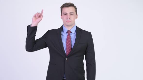 Young Happy Handsome Businessman Pointing Up