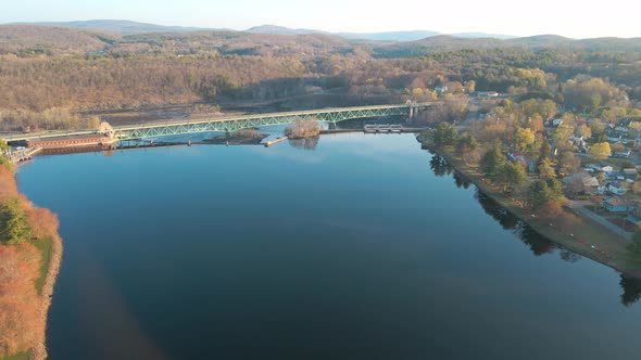 Aerial fly-in view over a blue lake in Greenfield, Massachusetts in the New England area. You can se
