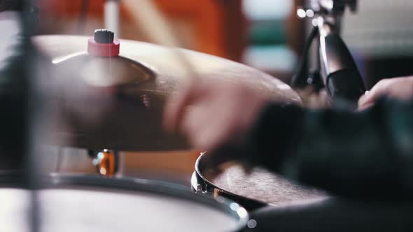 Inspired Man in Blue Shirt Playing Drums on Record