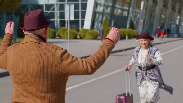 Senior Old Husband and Wife Retirees Tourists Reunion Meeting in Airport Terminal After Traveling