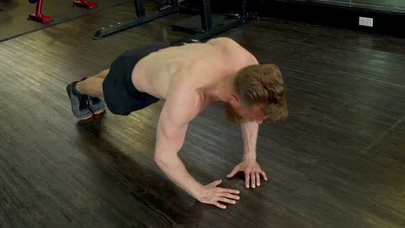 Athlete Doing a Diamond Push Up Routine in an Indoor Gym