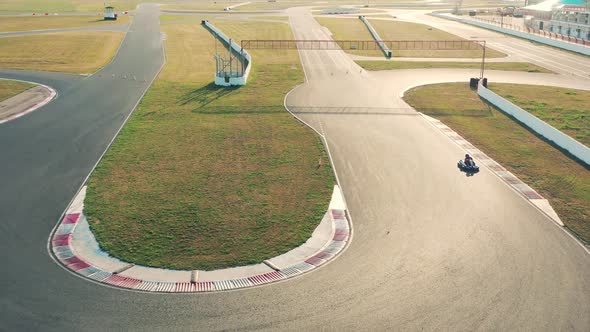 Top View of a Cart Racing Along the Asphalted Track