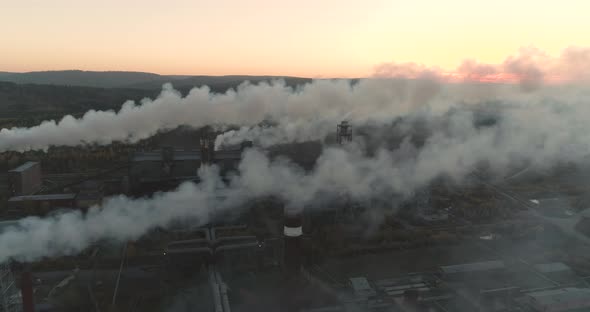 Aerial View Emission to the Atmosphere from Industrial Pipes Smokestack Chimneys.