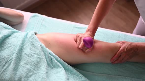 Unrecognizable Woman Lying on Massage Table Relaxing Vacuum Jars Therapeutic Massage