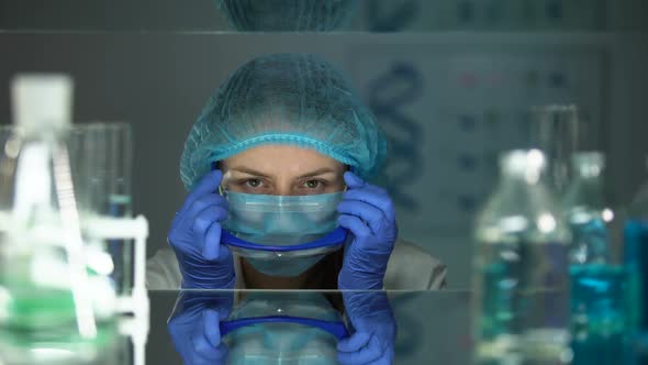 Researcher Putting on Protective Eyeglasses Before Working With Chemical Agents