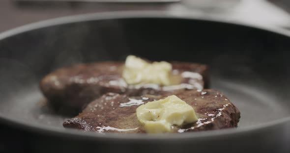 Slow Motion Butter Slide From Beef Steak on Nonstick Pan