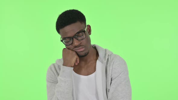 African Man Sleeping on Green Background