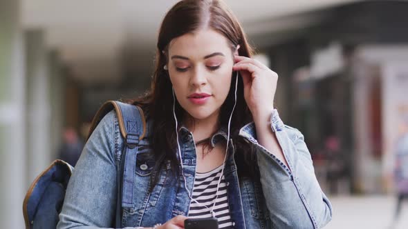 Young Caucasian woman looking at her phone