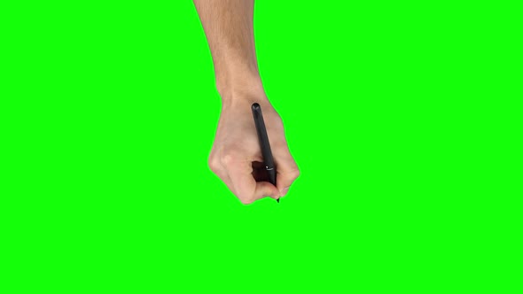 Male Hand with Liner Pen Is Writing on Green Screen Background. Close Up