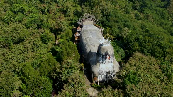 Gereja Ayam or Chicken Church surrounded by lush jungle, Magelang in Indonesia. Aerial top-down orbi