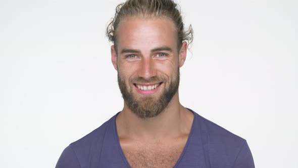 Closeup Caucasian Handsome Man Wearing Blue Tshirt Looking at Camera Smiling Broadly with White