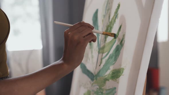 Woman Painting Green Plant of Canvas