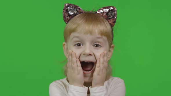 Girl in Headband with a Cat Ears Shows Amazement. Happy Four Years Old Child