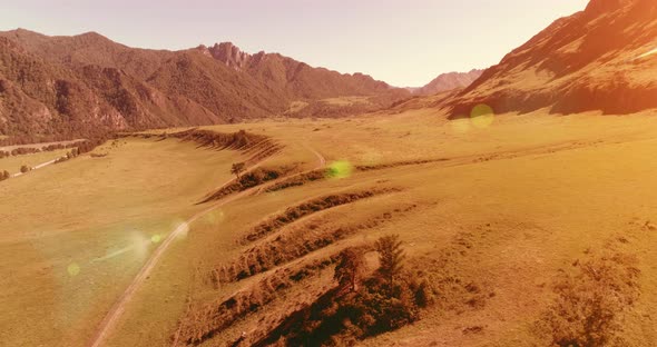 Aerial Rural Mountain Road and Meadow at Sunny Summer Morning