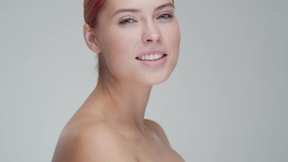 Studio portrait of young, beautiful and natural redhead woman. Beauty concept.