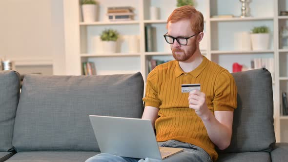 Redhead Man Making Successful Online Payment on Laptop 