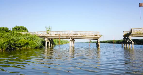 Old and Destroyed Bridge Over the River