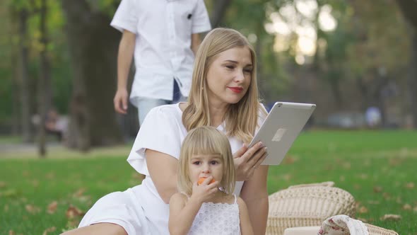 Pretty Caucasian Woman and Her Two Kids Spending Time Outdoors