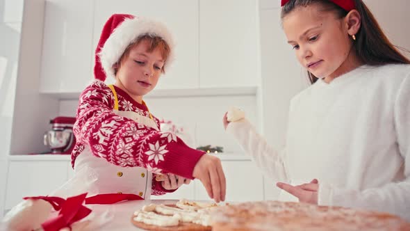 Happy Kids Girl and Boy Making Homemade Cake for Christmas at Light Home Interior