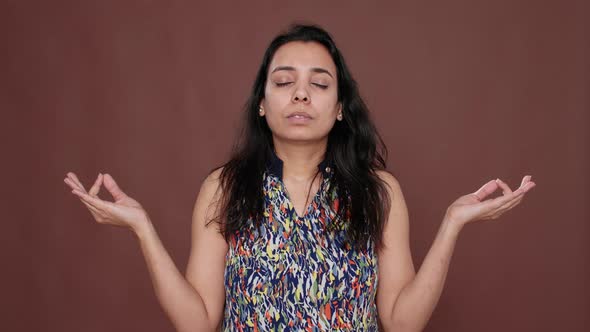 Portrait of Indian Peaceful Woman Doing Zen Meditation on Camera