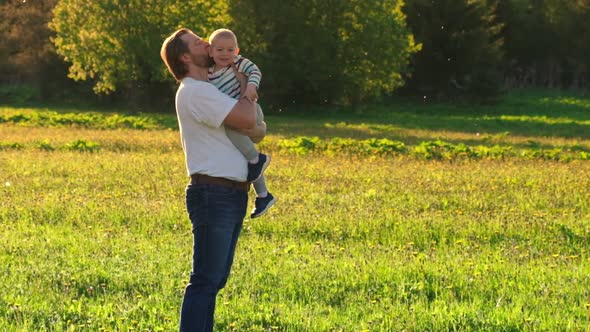 Father and Son Playing Outdoors at the Sunset Time