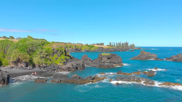 Beautiful 4k drone shot. Southwest of Hana Black sand beach and volcanic rocks.