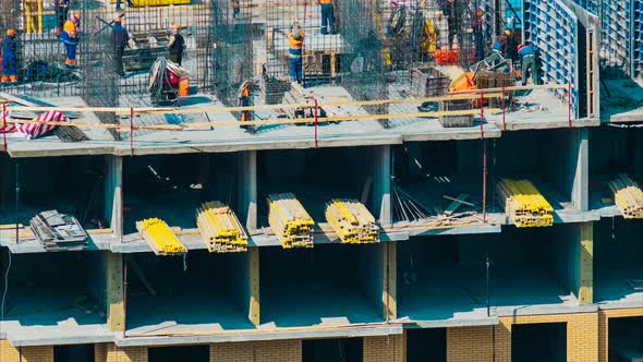 Builders in Hardhats Work with Modern Brick Construction