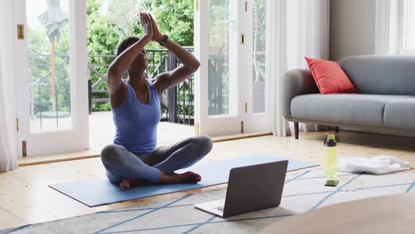 African american woman practicing yoga at home