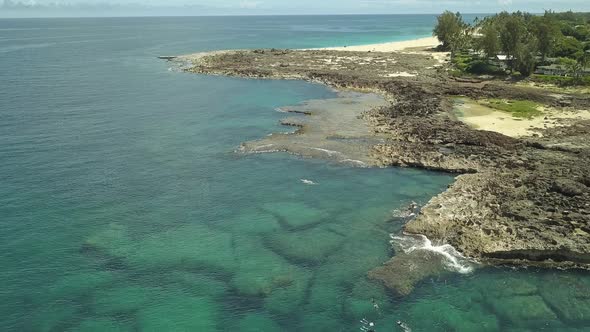 Aerial view of swimmers enjoying the clear water at Sharks cove