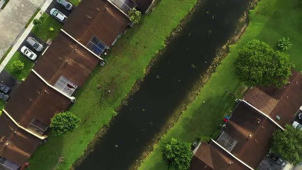 Ducks Behind Homes With River Aerial Rising Shot