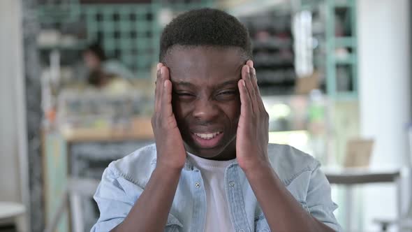 Stressed African Man Having Headache