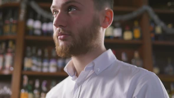 Young Handsome Man Waiting for Someone with Glass of Wine in Restorount Slowmo