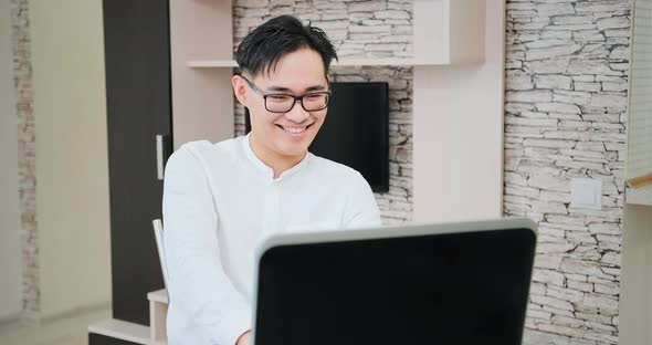 Shocked manager looks into black laptop display typing