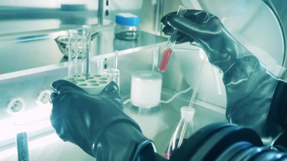 Glass Tube Is Getting Put Into Centrifuge Inside of a Vacuum Cabinet