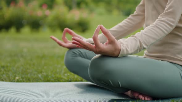 Woman hands practices yoga and meditates close up in lotus position.