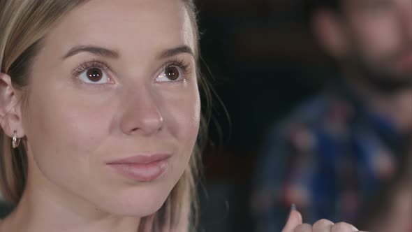 Smiling Young Woman Watching a Movie