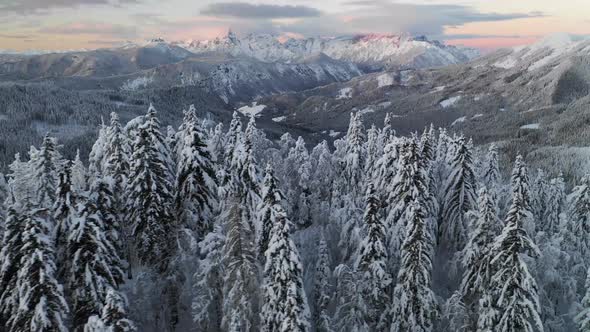 Flying over winter hills at sunrise