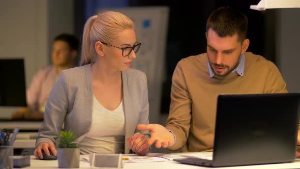 Business Team with Laptop Working at Night Office 