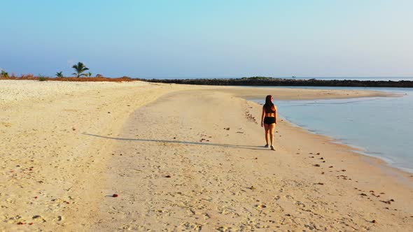 Female models posing on perfect bay beach voyage by transparent water and white sand background of T