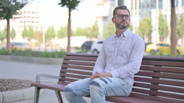 Young Adult Man Standing and Leaving After Sitting on Bench Outdoor