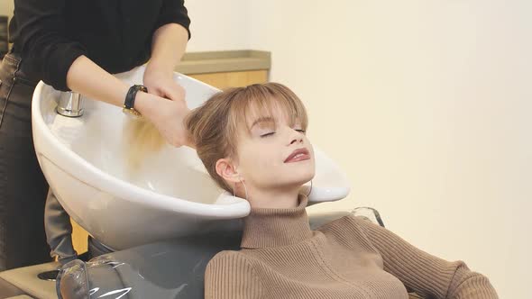 Professional Hairdresser in Beauty Saloon with Clients