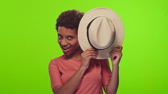 Young African American Woman Playing Hideandseek Conceal your Face Behind Hat