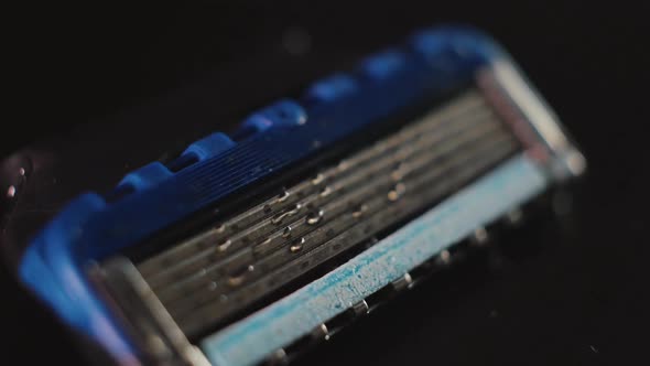 Razor Blade with Water Drops on a Dark Background