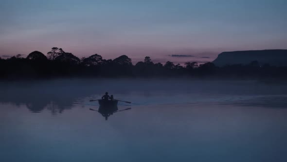 Rowing bow on fog covered river at Dusk