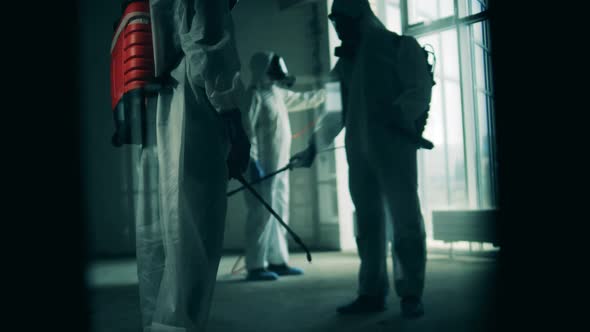 Group of Sanitary Workers During Disinfection Process