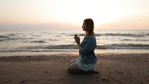 Young Woman Wears Rainbow Bracelet and Prays for LGBT Equal Rights at Sea