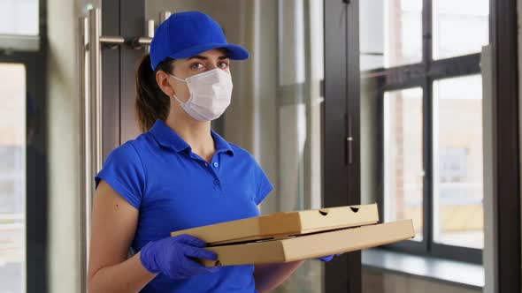 Delivery Woman in Face Mask with Pizza Boxes