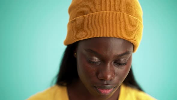 Smiling African woman opening eyes at the camera